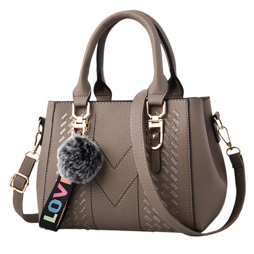 Women’s embroidered leather messenger bag with hairball accent - MELLIROSE
